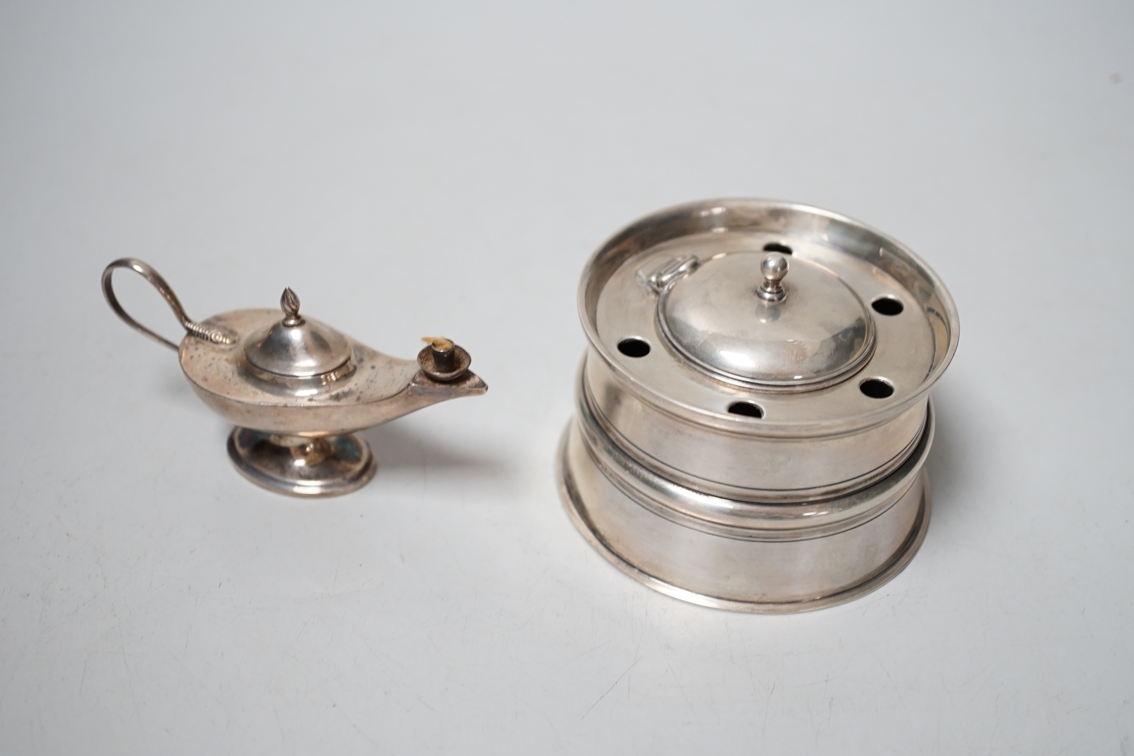 A late Victorina silver inkwell with five pen recesses, William & John Barnard, London 1889, diameter 86mm, and a small George V silver 'Aladdin's lamp' lighter.